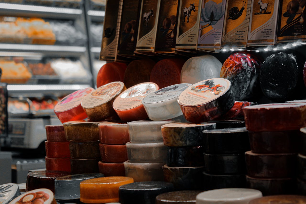 A vibrant display of artisan cheeses stacked in a local market setting.